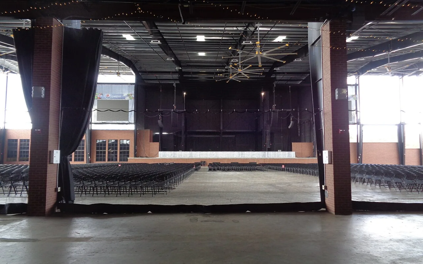 A concert venue in downtown Tallahassee decorated with string lights in the evening